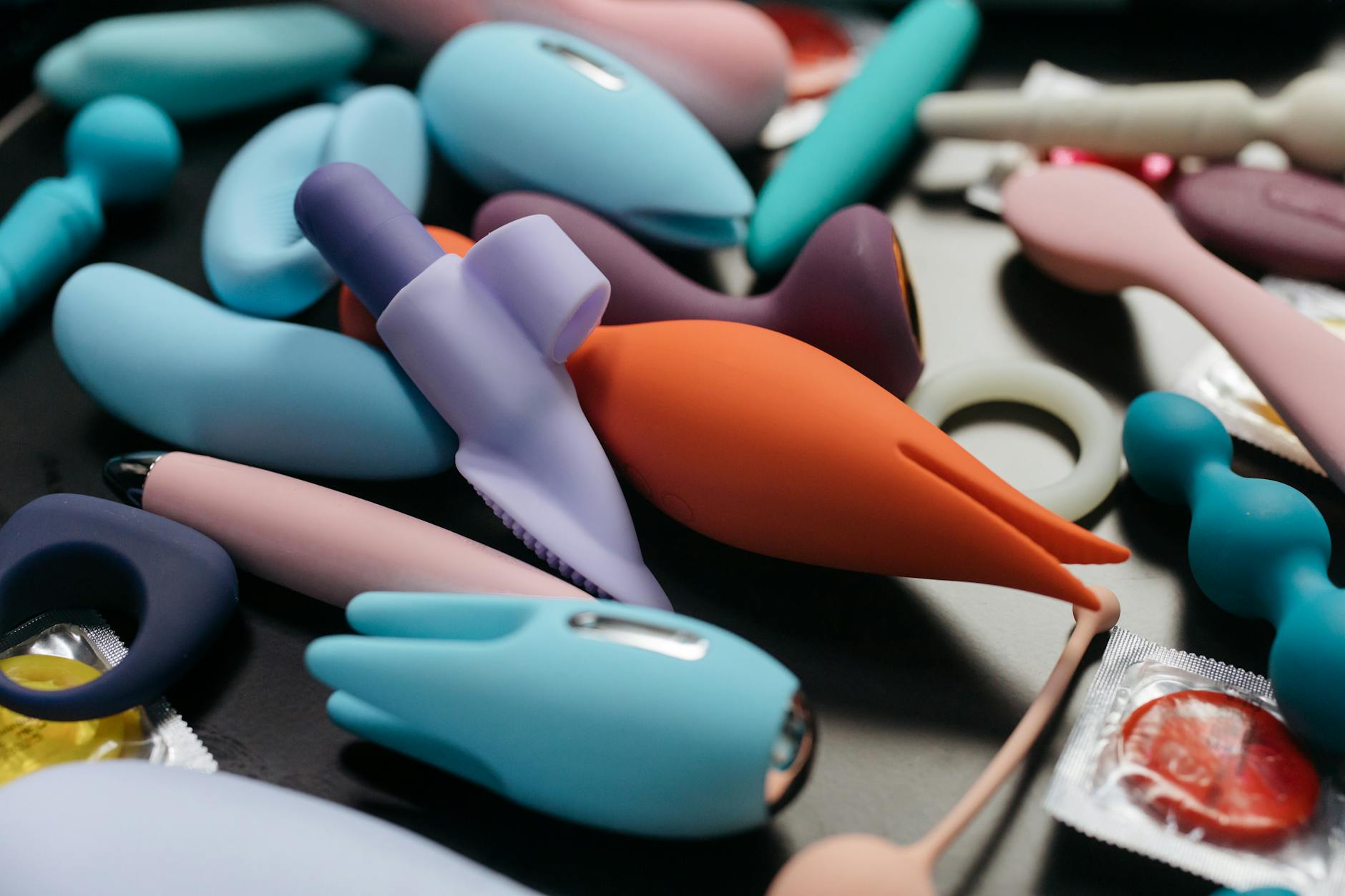 Colorful lemon vibrators and adult toys arranged on a surface, symbolizing pleasure and self-care