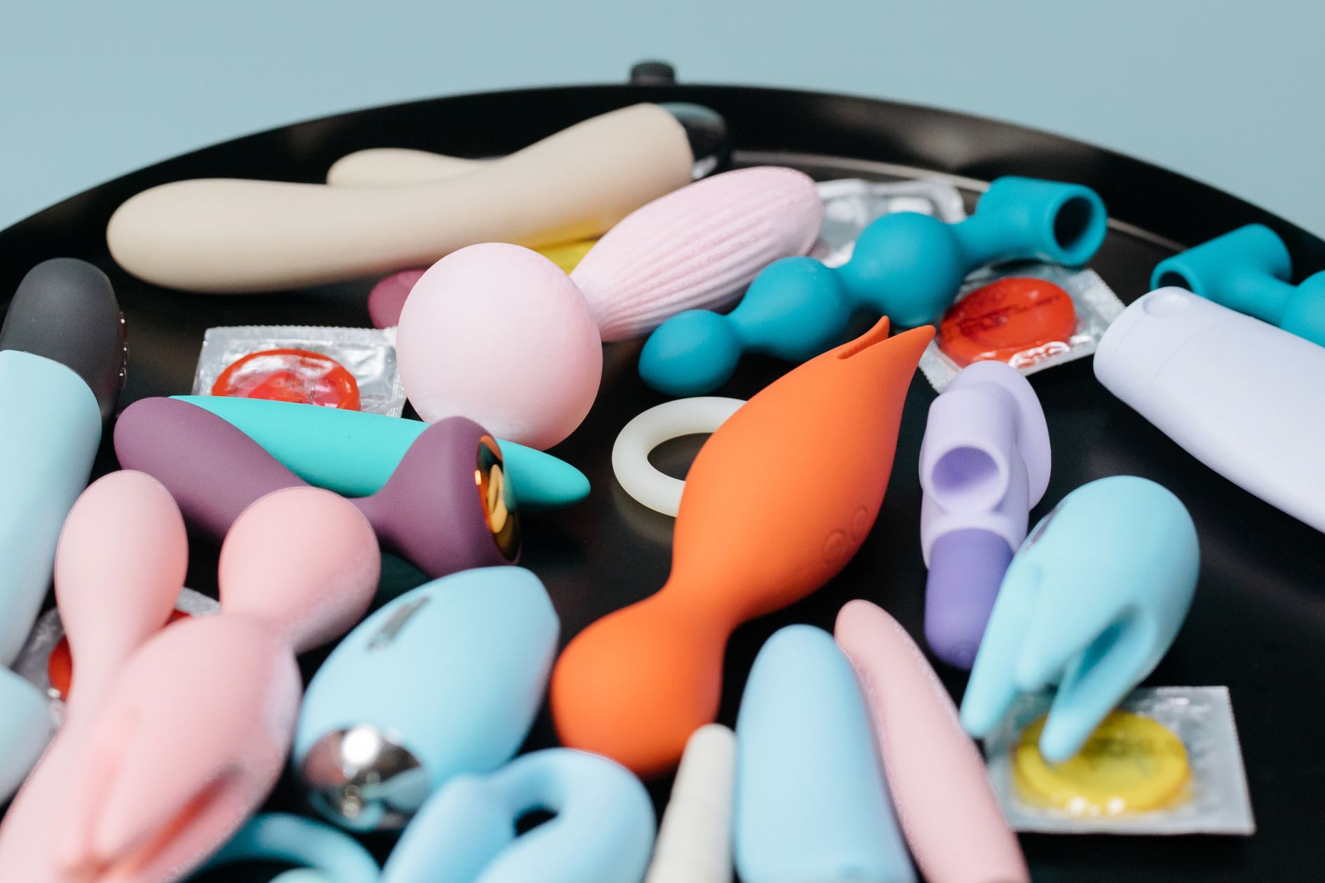 A collection of lemon clitoral vibrators and adult toys arranged on a black surface