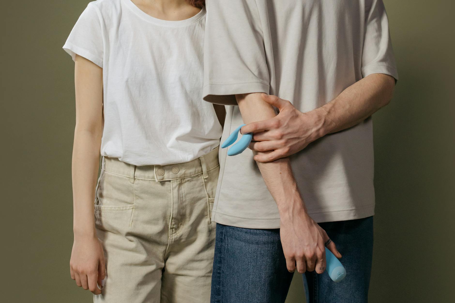 A couple standing close together indoors, exploring modern intimacy tools to rebuild their connection.